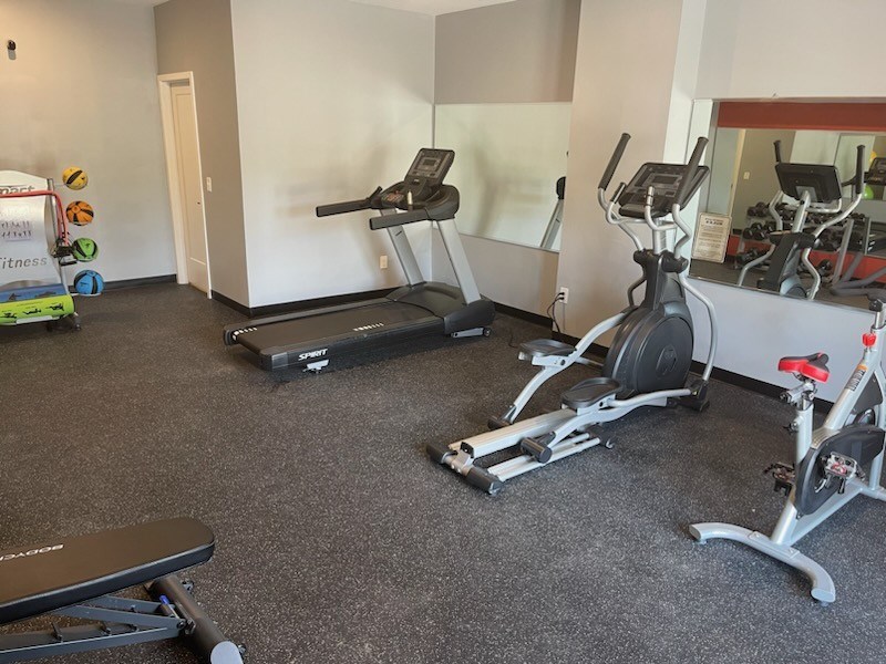 a gym with treadmills and exercise bikes